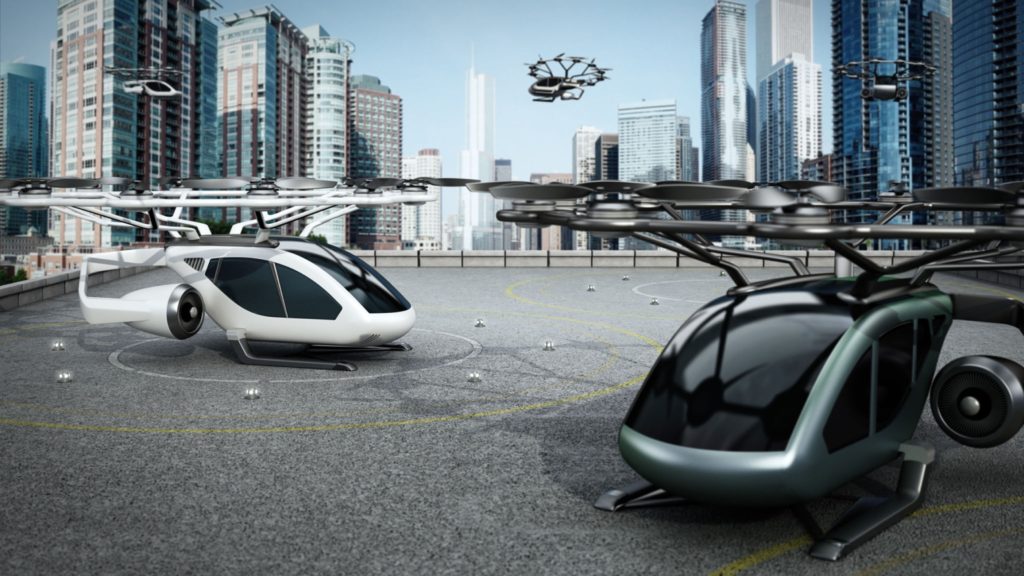 Conceptual rendering of eVTOL (electric vertical take-off and landing) aircrafts as a taxi shuttle service at the helipad on top of a building.