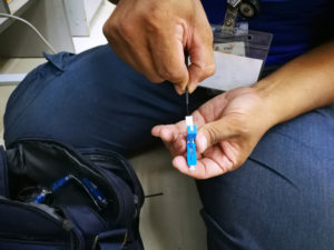 Technician cutting and fusing fiber optic cables.