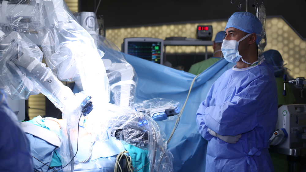 Surgeon monitoring a robotic, minimally invasive surgery where optical WDM is being used.