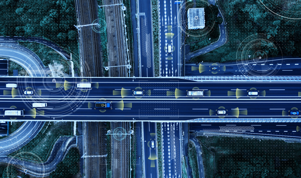 Inneos | Automotive Ethernet at 25 Gbps: Why Electromagnetic Compatibility Is Critical for Reliable Performance Top-down view of autonomous vehicles with sensors, navigating a futuristic highway.